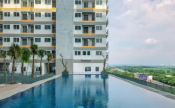 Soft Grey 1BR at Royal Sentul Park Apartment By Travelio