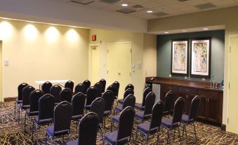a conference room with rows of chairs arranged in a semicircle , and a table in the middle of the room at Hampton Inn & Suites by Hilton Stroudsburg Pocono Mountains