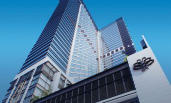 The photo shows a ground-level view of an office building and its reflection in another photo at Harbour Plaza Metropolis