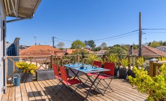 a wooden deck with a table and chairs set up for outdoor dining , surrounded by greenery at Dade