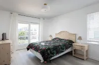 1 min private beach walk. Stylishly renovated with beach views! Hot tub & pool!