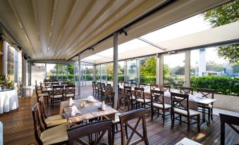 a large dining room with multiple tables and chairs arranged for a group of people to enjoy a meal at Hotel Continental