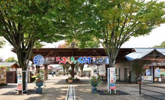 a wooden archway entrance to a park , with trees and benches providing shade for the area at Fairfield by Marriott Tochigi Utsunomiya