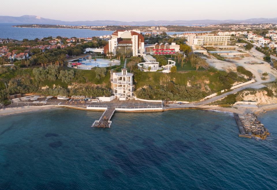 an aerial view of a large resort with a swimming pool , surrounded by water and buildings at Grand Hotel Ontur Cesme