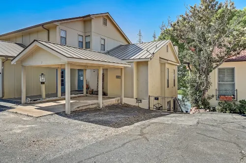 Dog-friendly water view home with inviting porch, AC, W/D, & modern charm