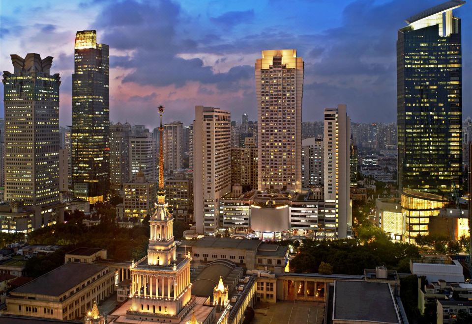 A city at night with tall buildings and skyscrapers in the foreground at The Portman Ritz-Carlton, Shanghai