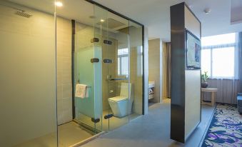 a modern bathroom with a glass door separating the toilet area from the rest of the room at Open Hotel