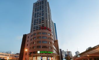 There is a large building in the center, surrounded by other buildings, with one on top at Holiday Inn Express Shanghai Zhenping