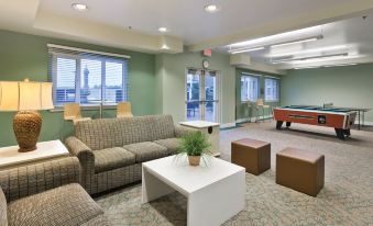 a large room with several couches , chairs , and tables arranged for a group of people to relax in at WorldMark Long Beach