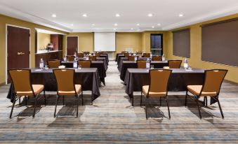 a conference room set up for a meeting , with chairs arranged in rows and a whiteboard on the wall at SpringHill Suites Minneapolis Eden Prairie