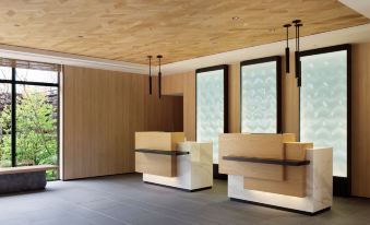 a modern office space with wooden walls , large windows , and a reception area equipped with wooden furniture at Fairfield by Marriott Gifu Seiryu Satoyama Park