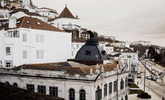 a cityscape with a black dome on top of a building and several white buildings in the background at Hotel Astoria