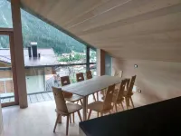 A beautiful wood and glass chalet at the edge of the Forest Hotels in Santo Stefano di Cadore