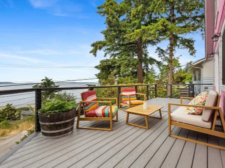 Darling pink beach house with epic views in a cozy community.