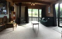 Log cabin in the mountains with indoor climbing wall, perfect for a family.