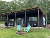 Charming shipping container home with lake view and boat ramp.