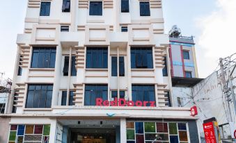 "a white building with a red sign that reads "" reddosol "" is shown in front of another building" at RedDoorz Plus @ Paal 2 Manado