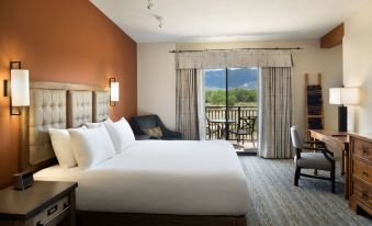 a large bed with white linens is in a room with an open door leading to a balcony at Hyatt Regency Tamaya Resort and Spa