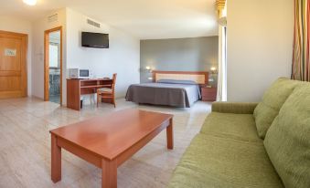 a modern hotel room with a bed , desk , and tv , along with a comfortable bed and desk at Estudios RH Vinaros