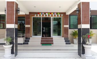 "a hotel entrance with a sign that reads "" arogetive "" and a set of stairs leading up to it" at Phetlada Pavilion & Resort