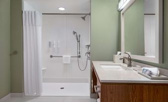 a bathroom with a walk - in shower , sink , and toilet is shown in this image at Home2 Suites by Hilton Joliet/Plainfield