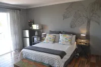 Cozy one bedroom suite, with a balcony, overlooking the pool and braai area.