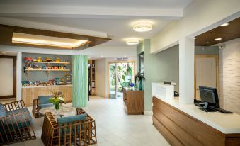 a modern , well - lit room with white walls and wooden furniture , featuring a kitchen area and an open - plan living area at Catalina Canyon Inn