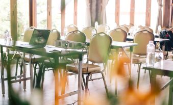 a large dining room with multiple tables and chairs arranged for a group of people at Sai Daeng Resort