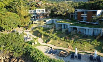 an aerial view of a resort with multiple buildings and a grassy area surrounded by trees at Wyndham Ilhabela Casa di Sirena