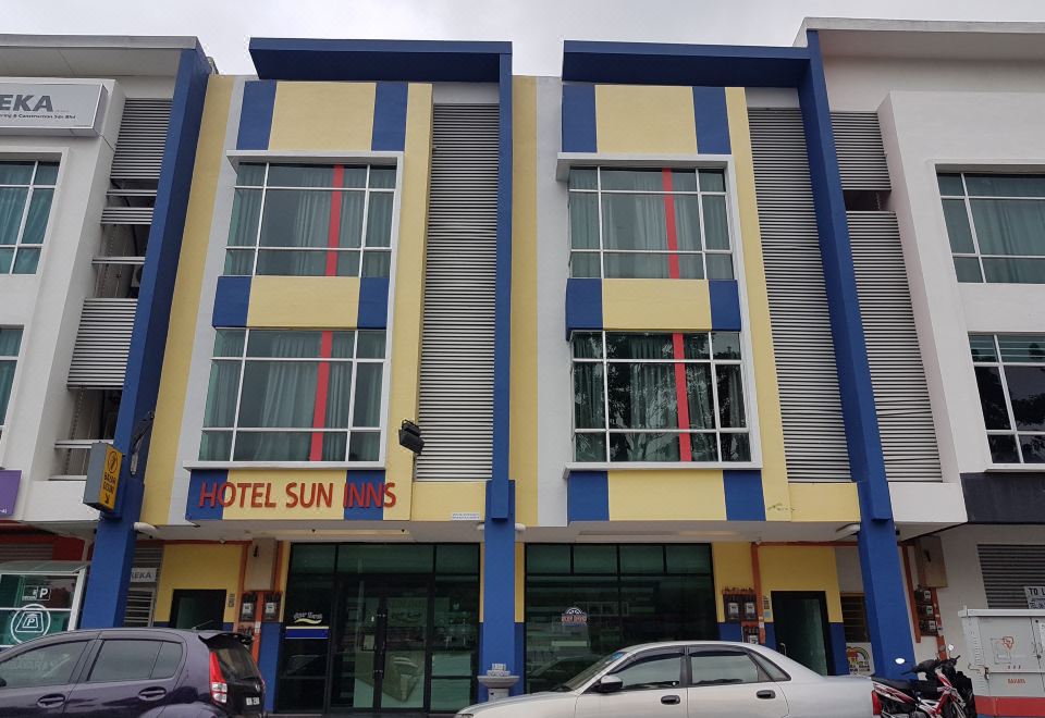 "a modern building with blue and yellow accents , featuring the name "" hotel sun nusa "" above the entrance" at Sun Inns Hotel Ayer Keroh