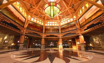 a large , open room with a high ceiling and wooden pillars , surrounded by intricate stone flooring at Four Winds Casino Resort – New Buffalo