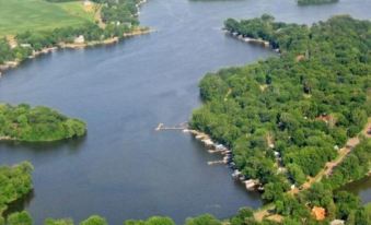 aerial view of a large body of water , possibly a lake or river , surrounded by trees and grass at Riverside Resort