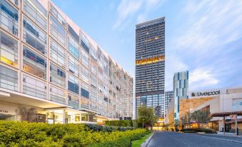 "a modern building with a large glass window is surrounded by greenery and has the words "" langham "" on it" at Hyatt Regency Andares Guadalajara