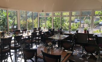 a dining room with several tables and chairs arranged for a group of people to enjoy a meal together at Michelangelos