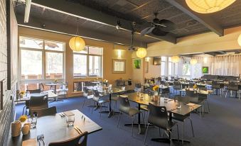 a large , well - lit restaurant with multiple dining tables and chairs arranged in an open space at Manjimup Kingsley Motel