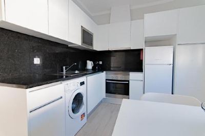a cozy living room with a fireplace , hardwood floors , and various pieces of furniture such as a coffee table , chairs , and a rug at Apartments Salomé Apartments Salomé Photo