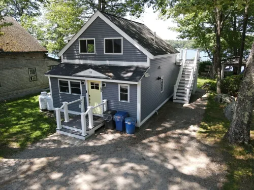 Relax in Raymond's lakefront 2-bedroom vacation home, just steps to Sebago Lake
