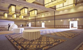 a large , empty banquet hall with multiple tables and chairs set up for an event at DoubleTree by Hilton Phoenix Tempe