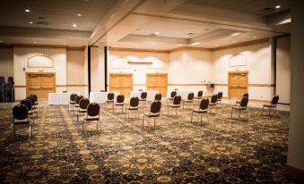 a large conference room with rows of chairs arranged in a semicircle , ready for a meeting at Ramada by Wyndham Uniontown