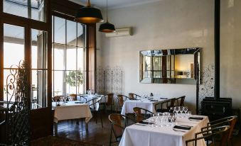 a well - lit dining room with tables and chairs arranged for a group of people to enjoy a meal at Terroir Auburn