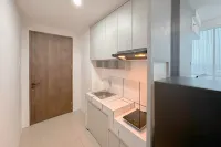 Combined Grey Toned 2BR Apartment at The City Square Surabaya By Travelio