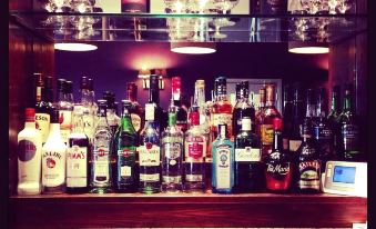 a well - stocked bar with a variety of liquor bottles and wine glasses arranged on the counter at Purdy Lodge