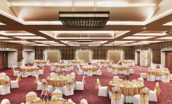 a large banquet hall with numerous round tables covered in white tablecloths , creating an elegant atmosphere at Hyatt Centric Janakpuri New Delhi