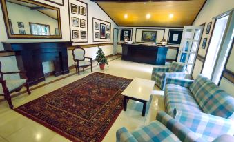 a spacious living room with multiple couches and chairs , creating a comfortable and inviting atmosphere at Lockwood Hotel Murree