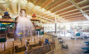 an indoor water park with multiple pools , slides , and play areas for children and adults at Great Wolf Lodge Grapevine