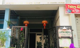 "a storefront with a sign that says "" memory "" and "" happy '"" on it , and potted plants in front of the entrance" at Memory Homestay Hue