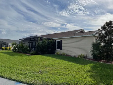 Charming Corner Lot with Golf Cart and Screened Lanai - Inviting Escape