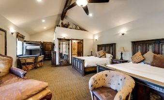 a large , luxurious bedroom with multiple beds and comfortable seating , along with various furnishings and decorations at North Texas Jellystone Park