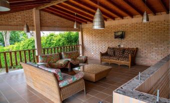 a patio area with brick walls , a wooden ceiling , and a variety of seating options at Hotel la Perla