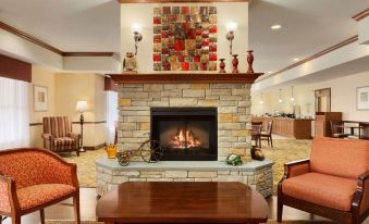 a hotel lobby with a fireplace , couches , and chairs arranged in a cozy manner for guests at Country Inn & Suites by Radisson, Ashland - Hanover, VA